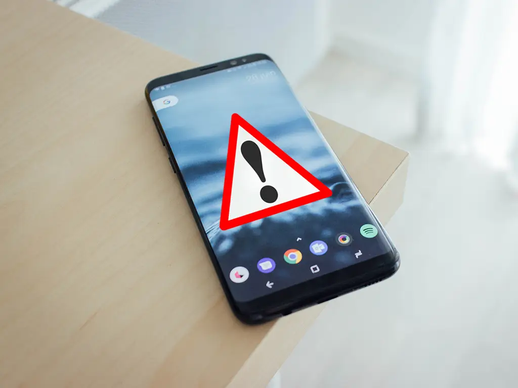 Broken smartphone with shattered cracked screen and water damage indicators