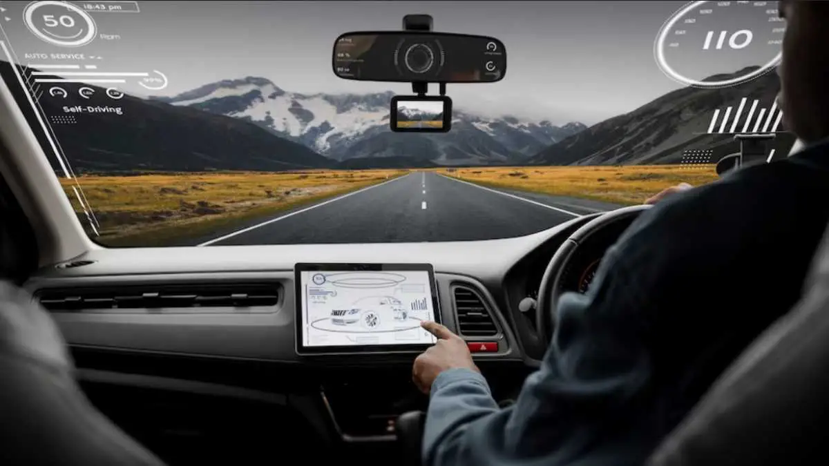 Modern car dashboard showing ADAS interface with lane assist, adaptive cruise control, and sensor visualizations