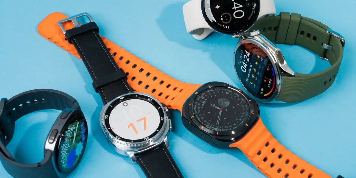 Collection of colorful smartwatches with vibrant straps and modern faces on blue background