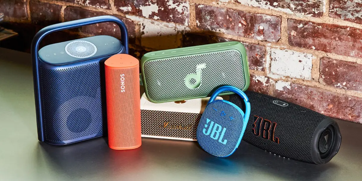 Collection of premium portable Bluetooth speakers from Sonos, JBL, Marshall, and others displayed together for indoor-ou